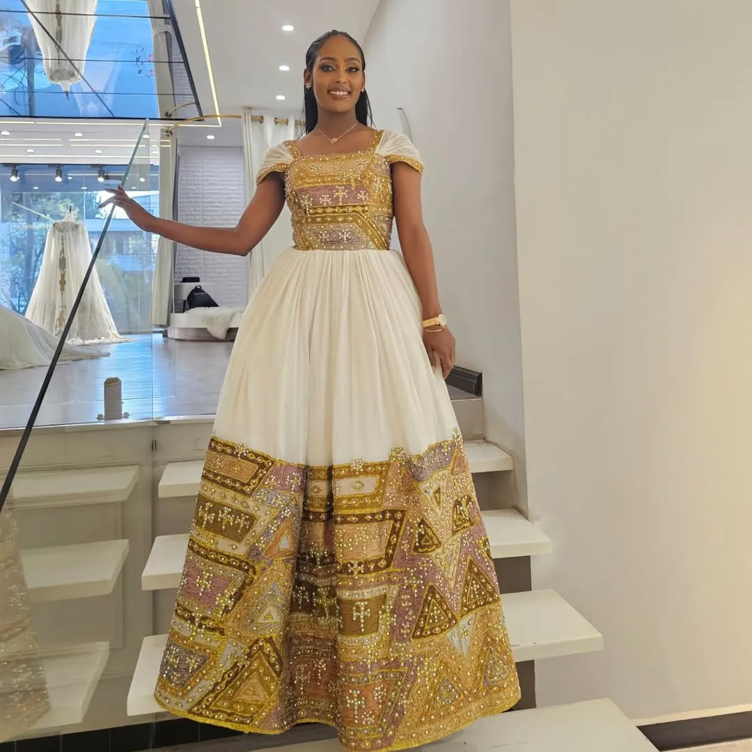 Shimmering Golden Habesha Dress: Beaded Cross Ornaments on Traditional Ethiopian Dress Gorgeous Ethiopian Wedding Dress